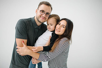 Young family hugging