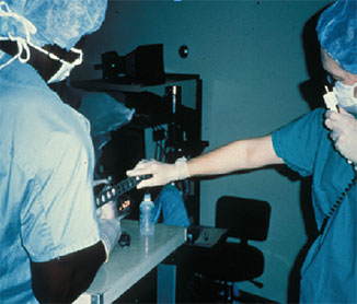 Dr. McDonald performing retinoscopy on a PRK postop monkey in 1987
